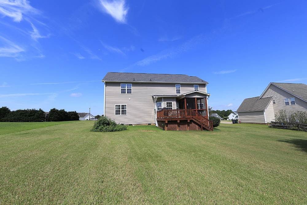 214 Steve Ridge Willow Spring, NC 27592 - Photo 25 of 29 Screened porch and sturdy open deck - plus great level back yard for kids, pets, gardening -just enjoying the space. Exterior Back