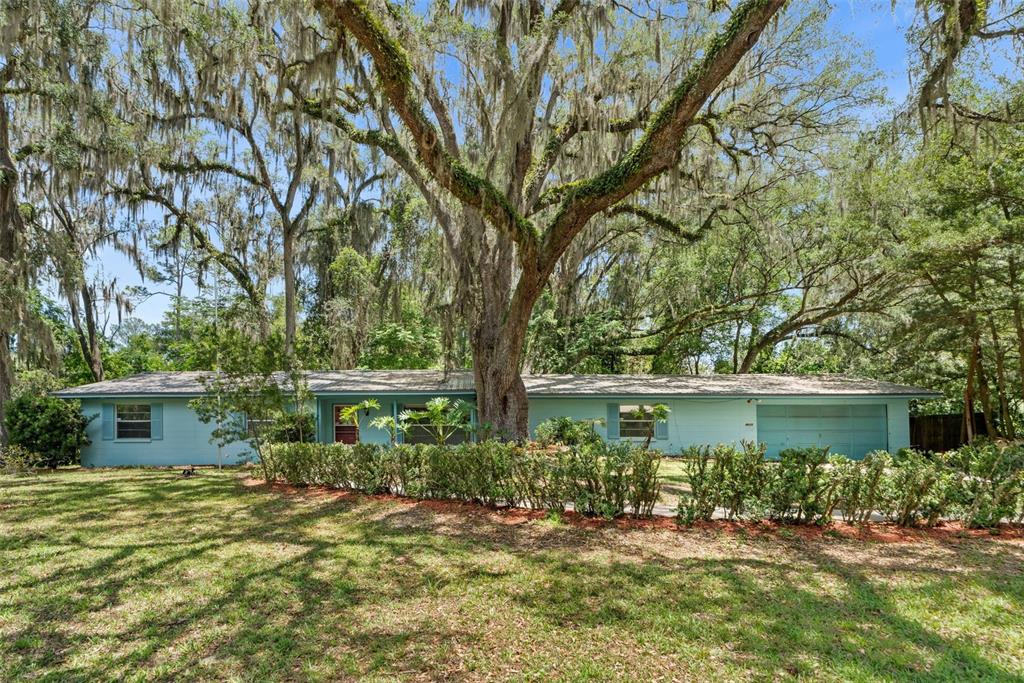 4825 Southwest 19th Street Gainesville, FL 32608 - Photo 1 of 40 a front view of a house with a yard
