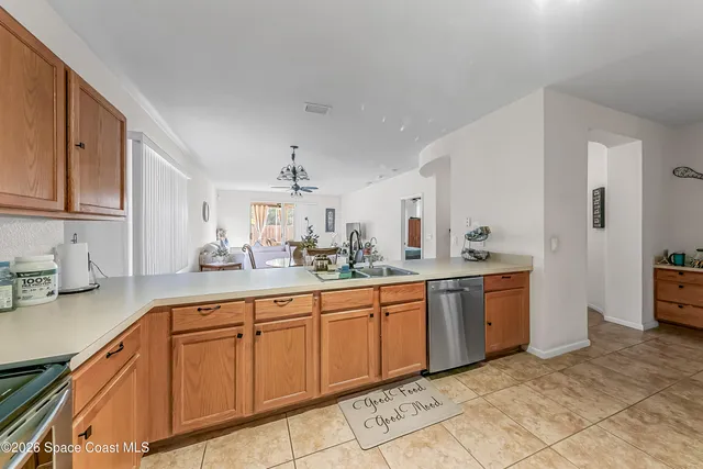a large kitchen with kitchen island granite countertop a sink white cabinets and white appliances
