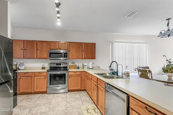 a kitchen with a sink stove top oven and microwave