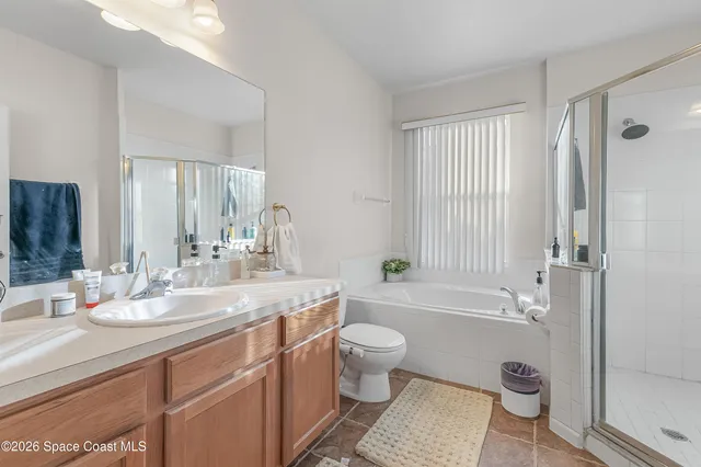 a bathroom with a granite countertop toilet a sink and a bathtub