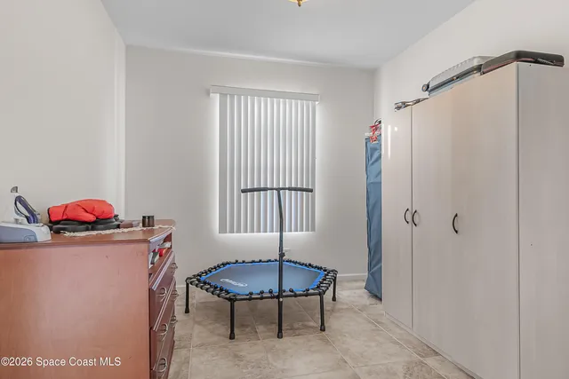 a living room with furniture a window and a potted plant