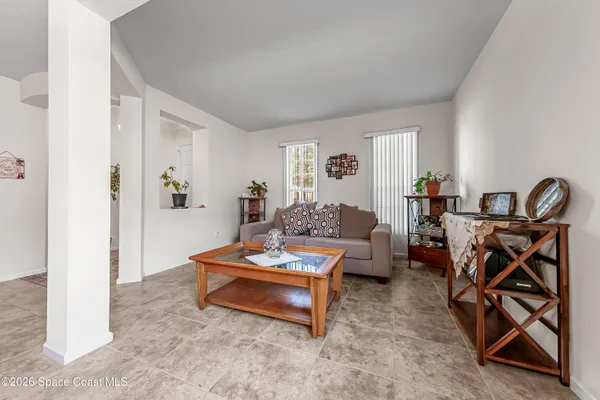 a living room with furniture a rug and a window