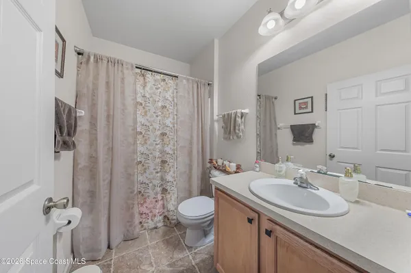 a bathroom with a sink toilet a mirror and shower