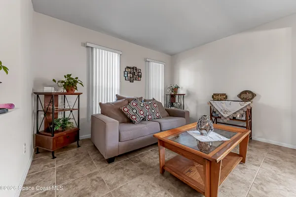 a living room with furniture and a potted plant
