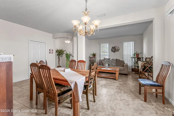 a view of a dining room with furniture and a chandelier