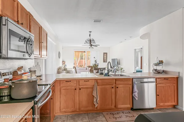 a kitchen with white cabinets and sink