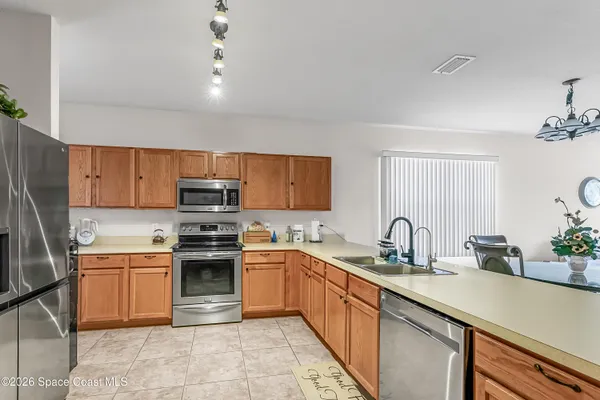a kitchen with a sink stainless steel appliances and cabinets