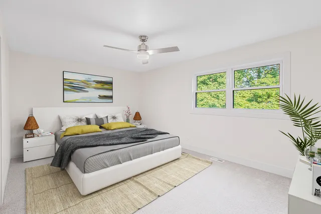 a bedroom with a bed and a painting on the wall