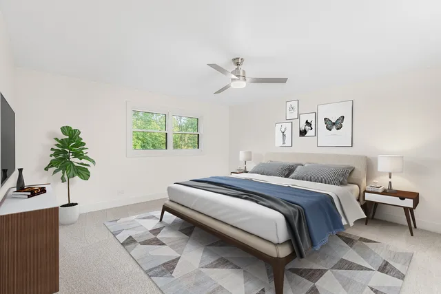a bedroom with a large bed and a potted plant