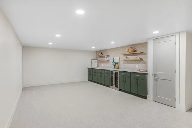 a view of a kitchen with refrigerator and cabinets