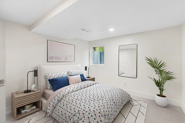 a bedroom with a bed and a couch