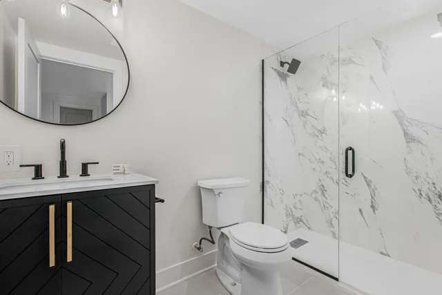 a bathroom with a sink a toilet and a mirror