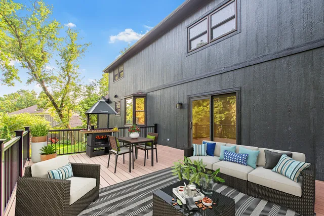 a view of a patio with couches table and chairs and potted plants