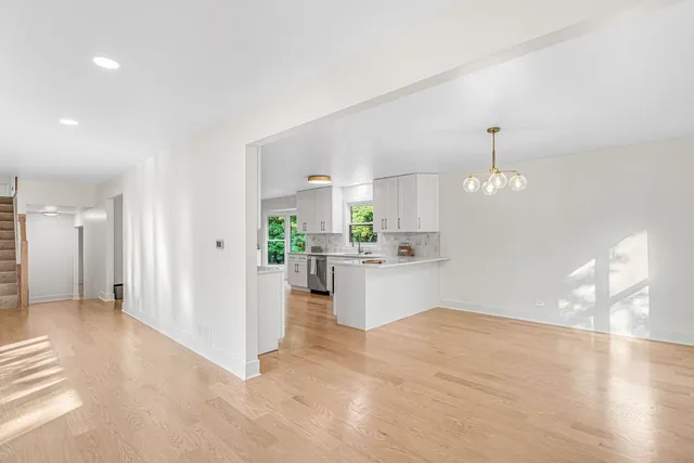 a view of a kitchen with refrigerator and windows