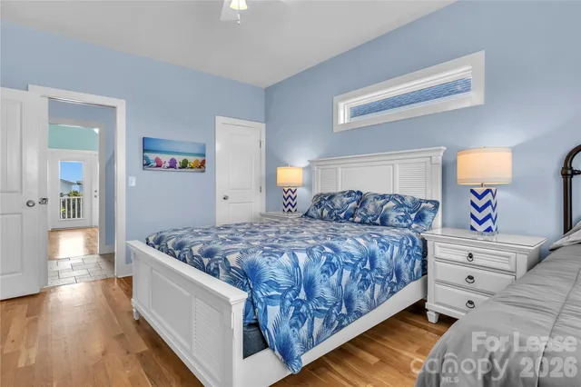 a bedroom with a large bed and a wooden floor