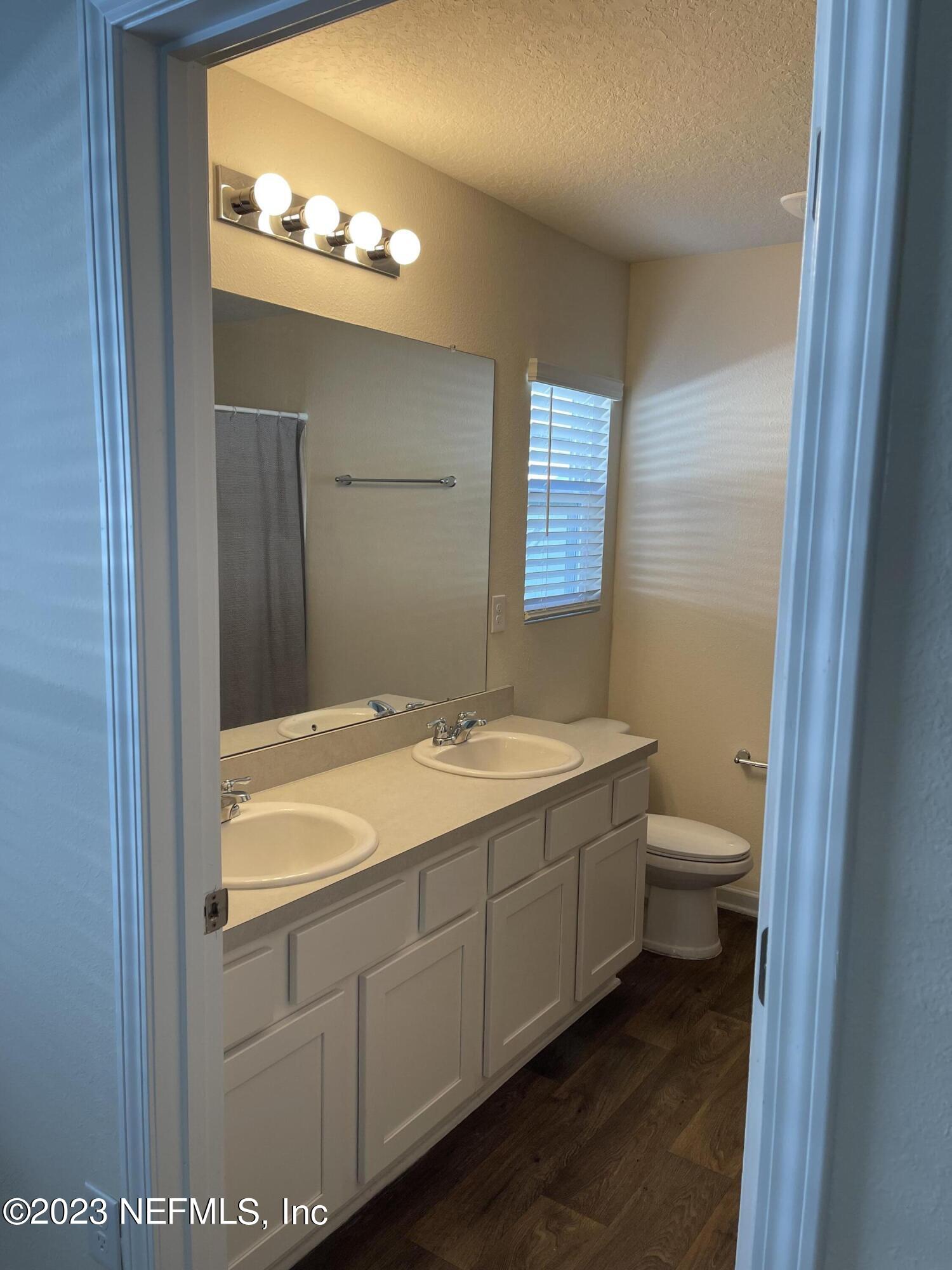581 Morgans Treasure Road St. Augustine, FL 32084 - Photo 8 of 20 a bathroom with a granite countertop sink toilet and mirror