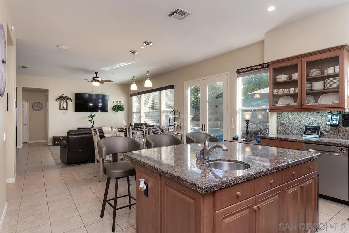16333 Deer Ridge Road San Diego, CA 92127 - Photo 11 of 43 a kitchen with granite countertop a sink and cabinets