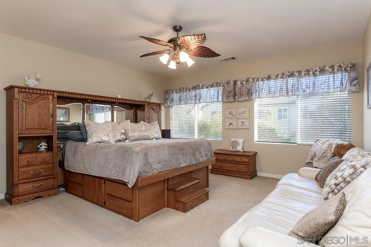 16333 Deer Ridge Road San Diego, CA 92127 - Photo 21 of 43 a bedroom with a bed couch and window