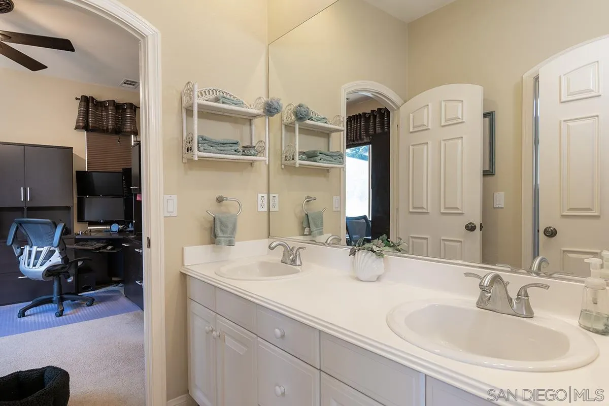 16333 Deer Ridge Road San Diego, CA 92127 - Photo 31 of 43 a bathroom with a double vanity sink and a mirror