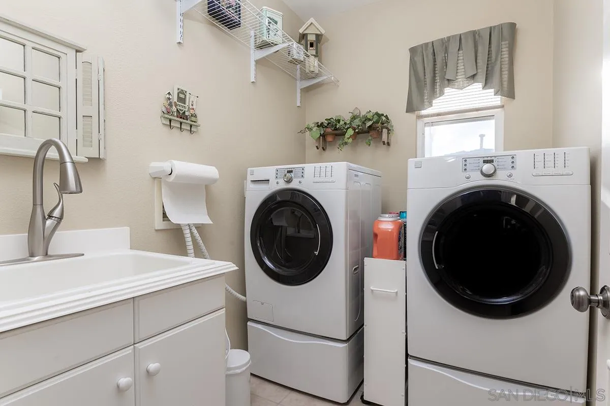 16333 Deer Ridge Road San Diego, CA 92127 - Photo 33 of 43 a utility room with sink dryer and washer