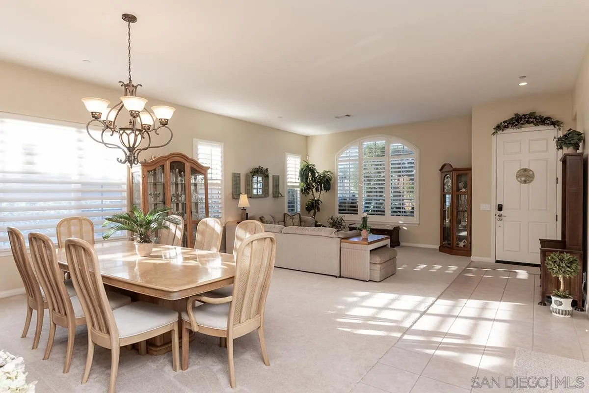 16333 Deer Ridge Road San Diego, CA 92127 - Photo 4 of 43 a dining room with furniture a chandelier and window