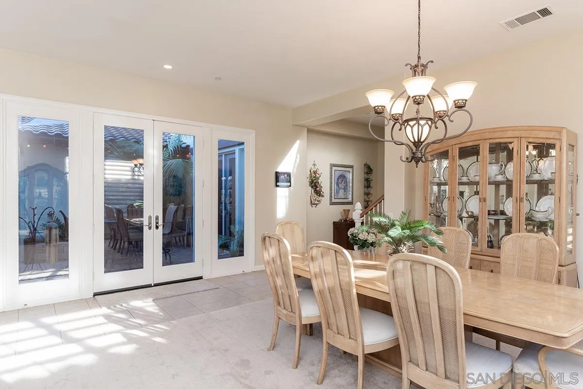 16333 Deer Ridge Road San Diego, CA 92127 - Photo 7 of 43 a view of a dining room with furniture and chandelier