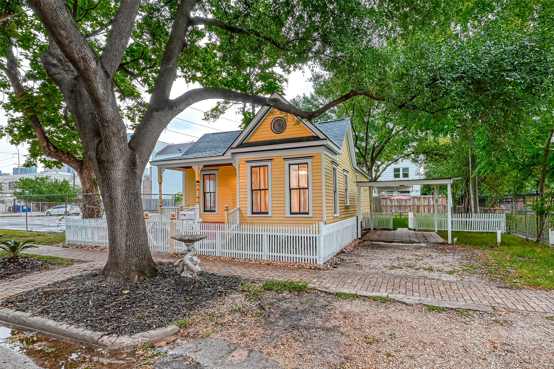 2009 State Street Houston, TX 77007 - Photo 2 of 42 Strategically situated on this over-sized wooded lot, there is covered parking n the west side of the home.