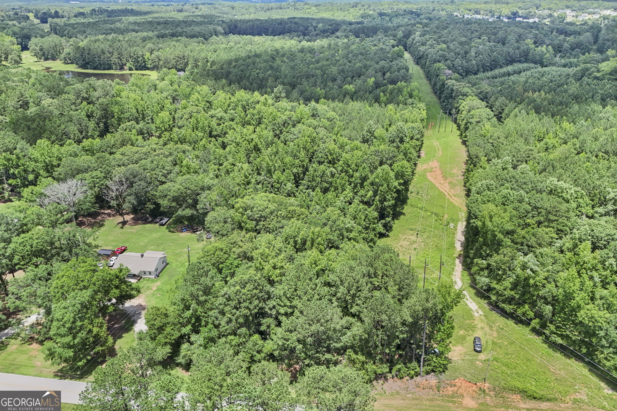 11.59-ac Hunt Road LaGrange, GA 30241 - Photo 11 of 34 an aerial view of residential house with outdoor space and trees all around