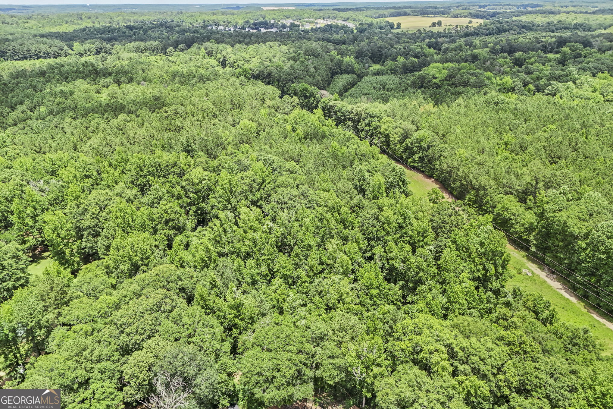 11.59-ac Hunt Road LaGrange, GA 30241 - Photo 16 of 34 an aerial view of residential house with outdoor space and trees all around