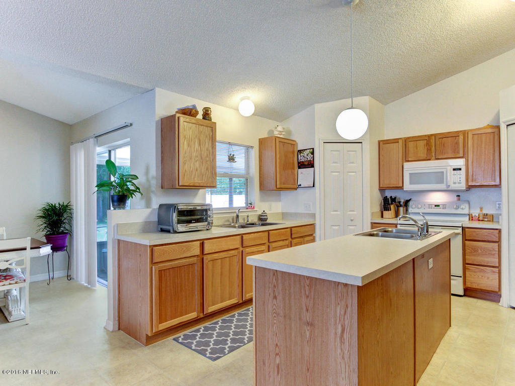 3187 Shadow Creek Road Jacksonville, FL 32226 - Photo 5 of 24 a kitchen with a sink stove and cabinets