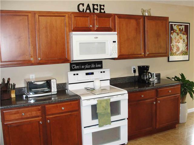 1025 Fulman Road Hendersonville, TN 37075 - Photo 7 of 11 a kitchen with stainless steel appliances granite countertop a stove a sink and a microwave