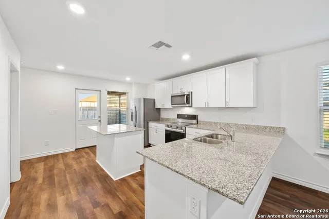 a kitchen with sink and refrigerator