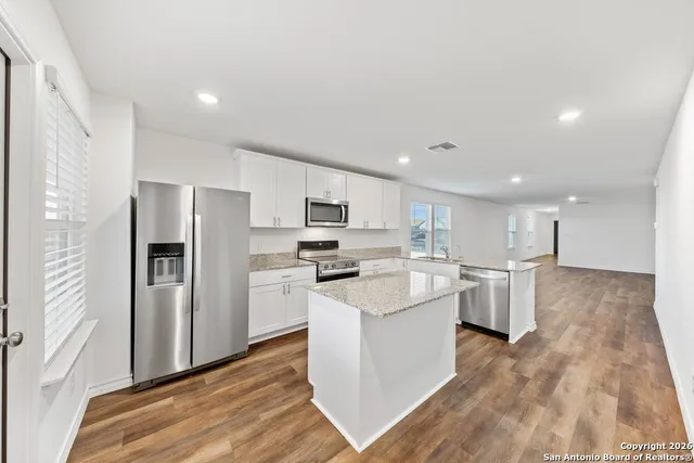 a kitchen with refrigerator and cabinets