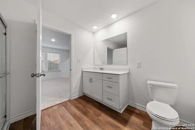 a bathroom with a toilet a sink and mirror