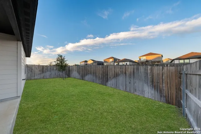 a view of a backyard with pathway