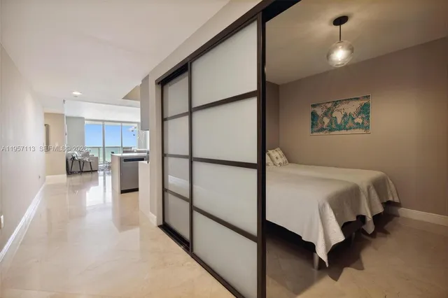 a spacious bedroom with a bed and a chandelier