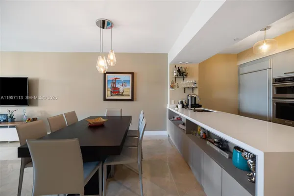 a large kitchen with a table and chairs
