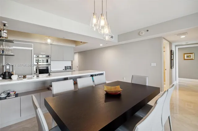 a living room with stainless steel appliances kitchen island granite countertop furniture and a kitchen view