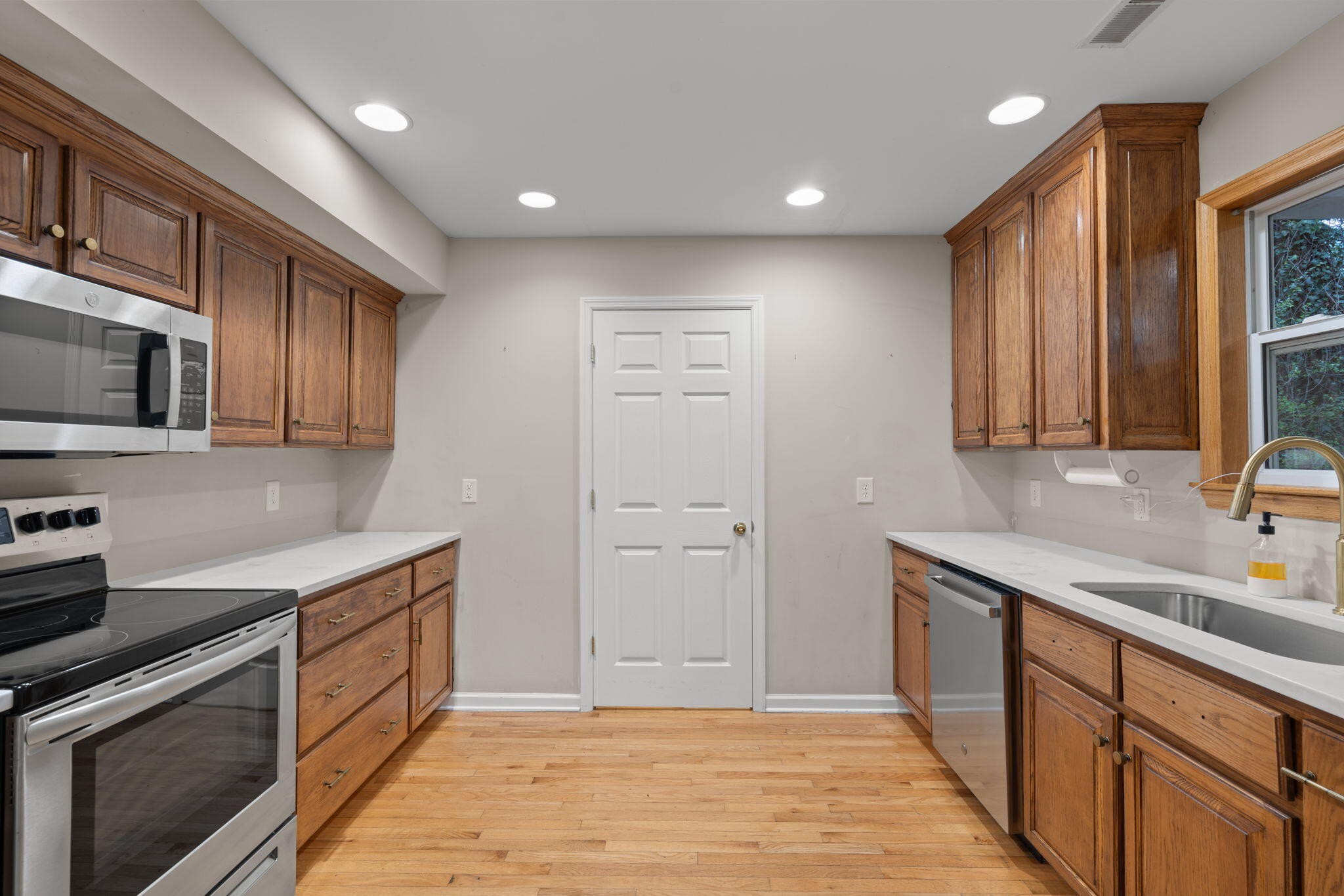 439 Town Creek Road Benton, TN 37307 - Photo 11 of 30 a kitchen with a sink wooden cabinets and stainless steel appliances