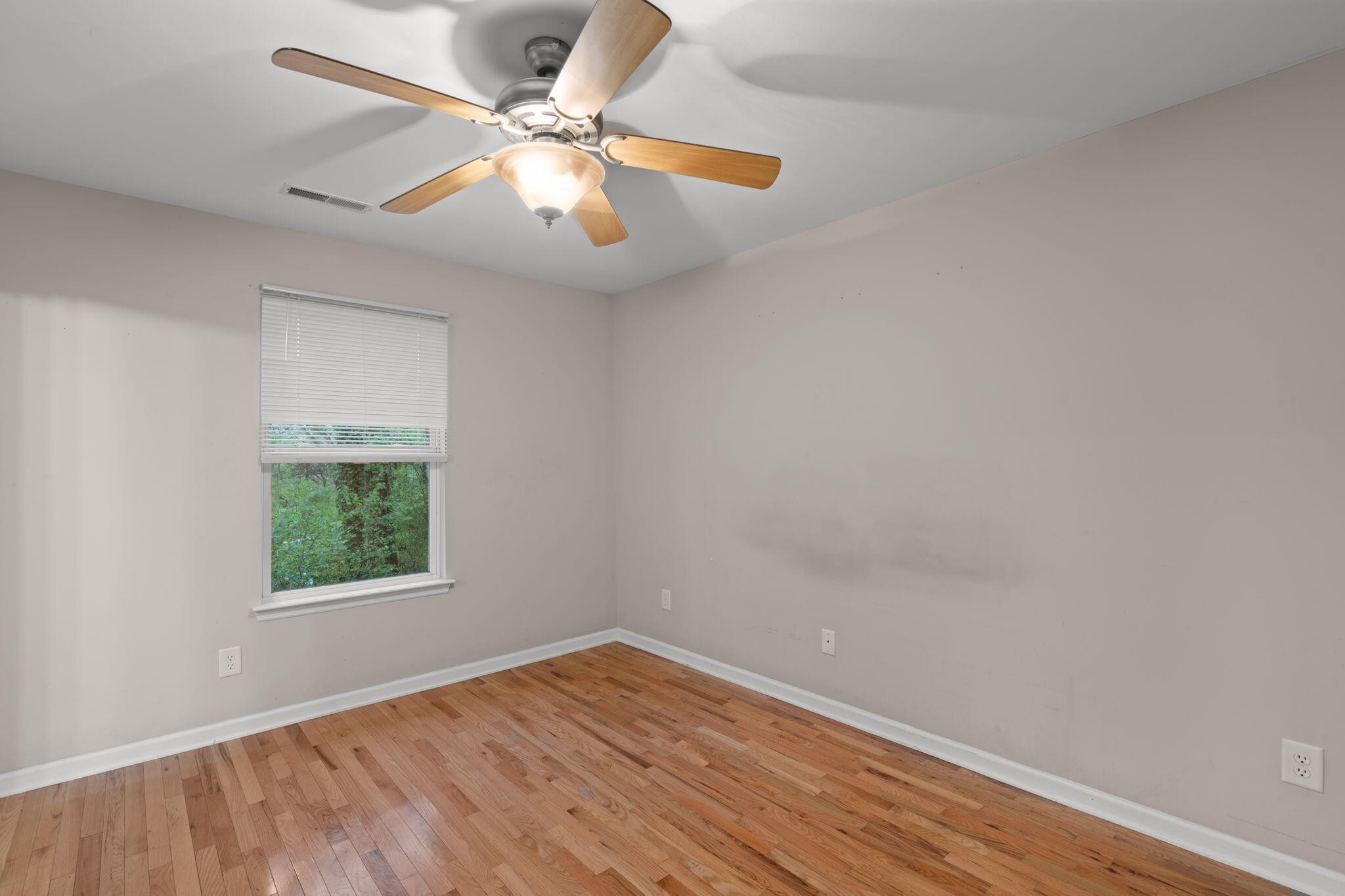 439 Town Creek Road Benton, TN 37307 - Photo 13 of 30 an empty room with a window and a ceiling fan