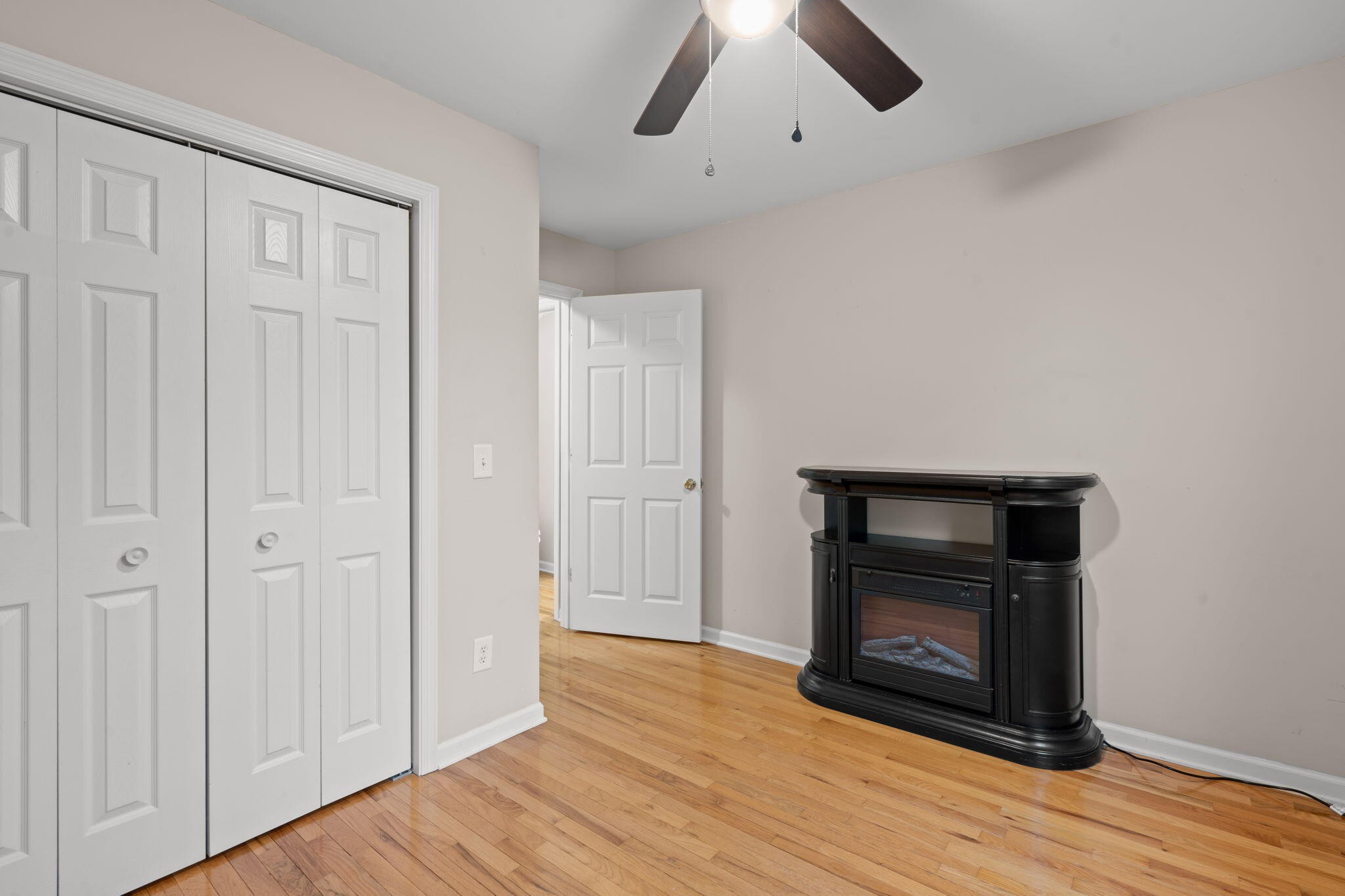 439 Town Creek Road Benton, TN 37307 - Photo 20 of 30 a view of an empty room with wooden floor and a fireplace