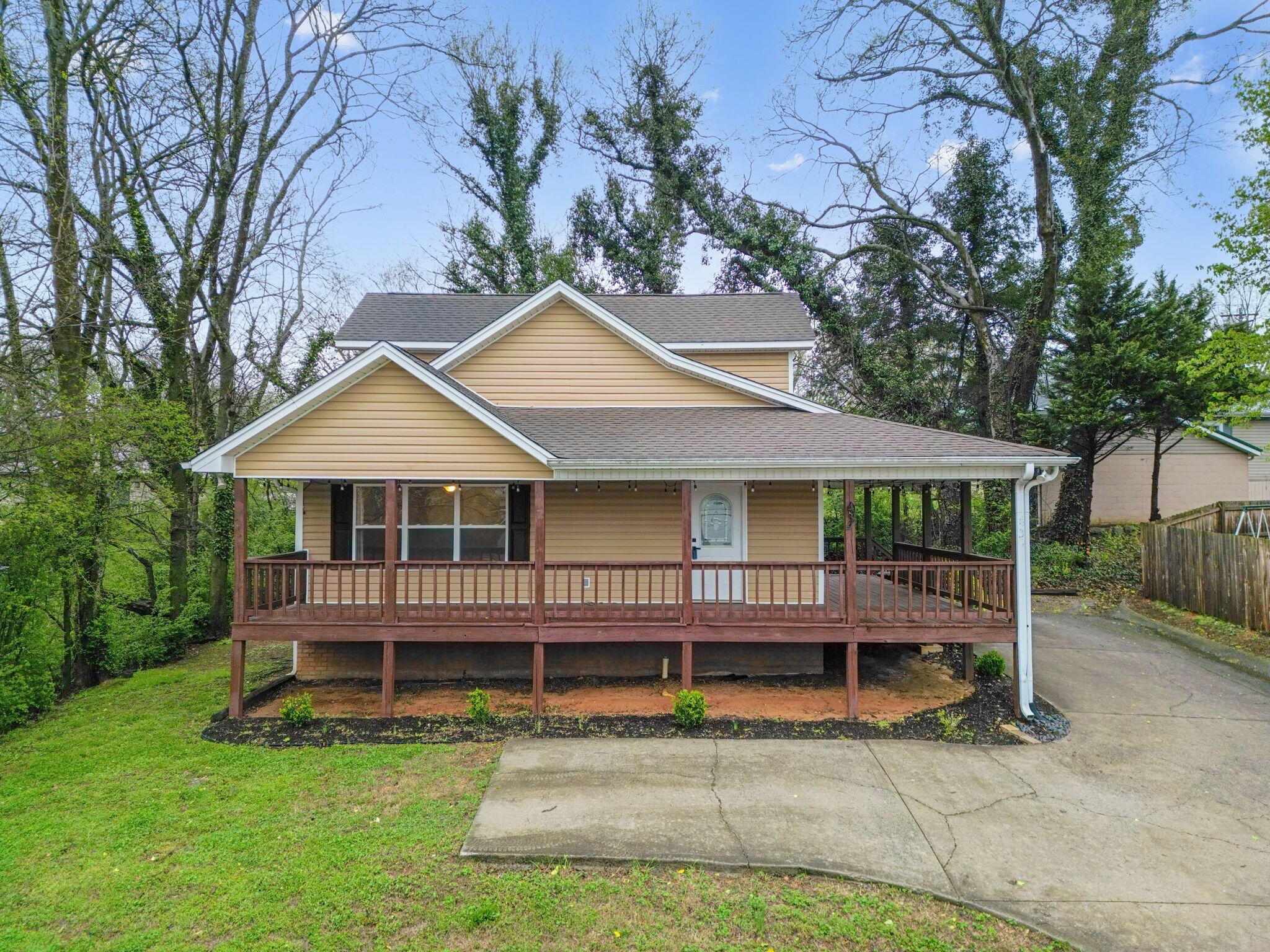 439 Town Creek Road Benton, TN 37307 - Photo 2 of 30 a view of a house with a yard and deck