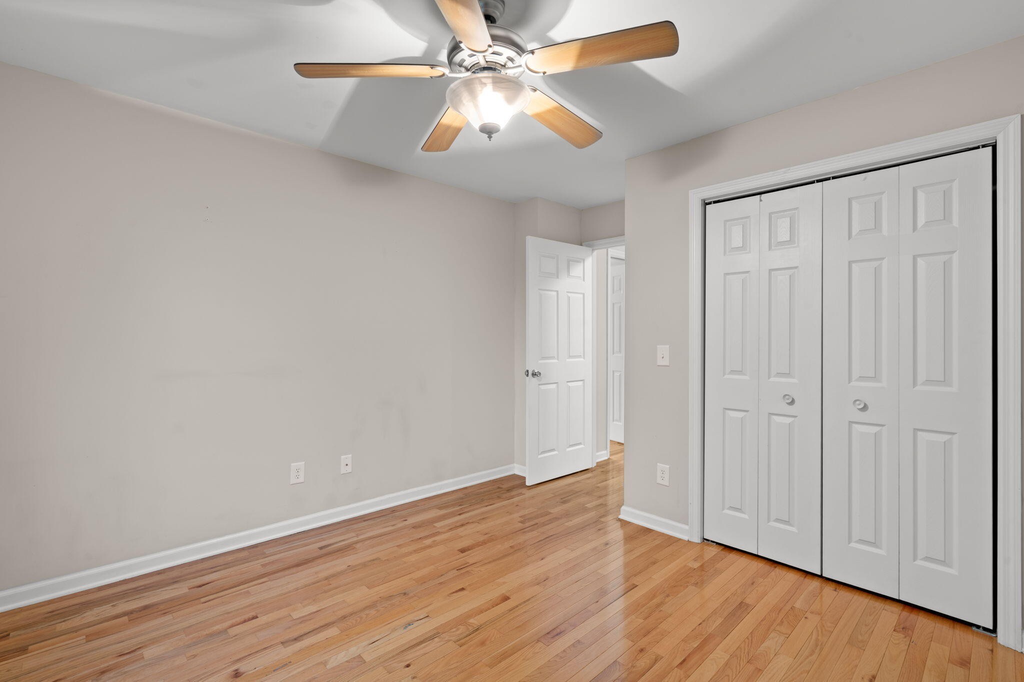 439 Town Creek Road Benton, TN 37307 - Photo 25 of 30 an empty room with wooden floor fan and windows