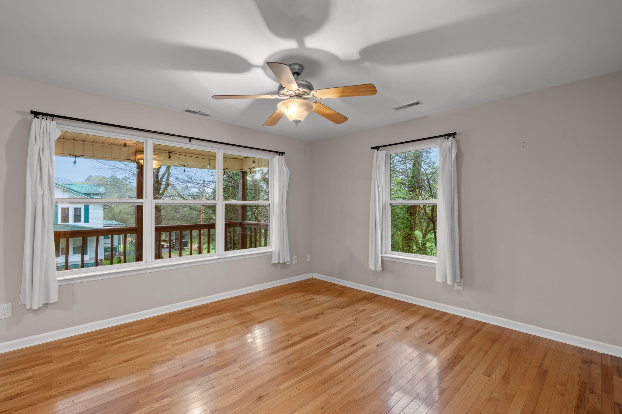 439 Town Creek Road Benton, TN 37307 - Photo 6 of 30 a view of an empty room with wooden floor and a window