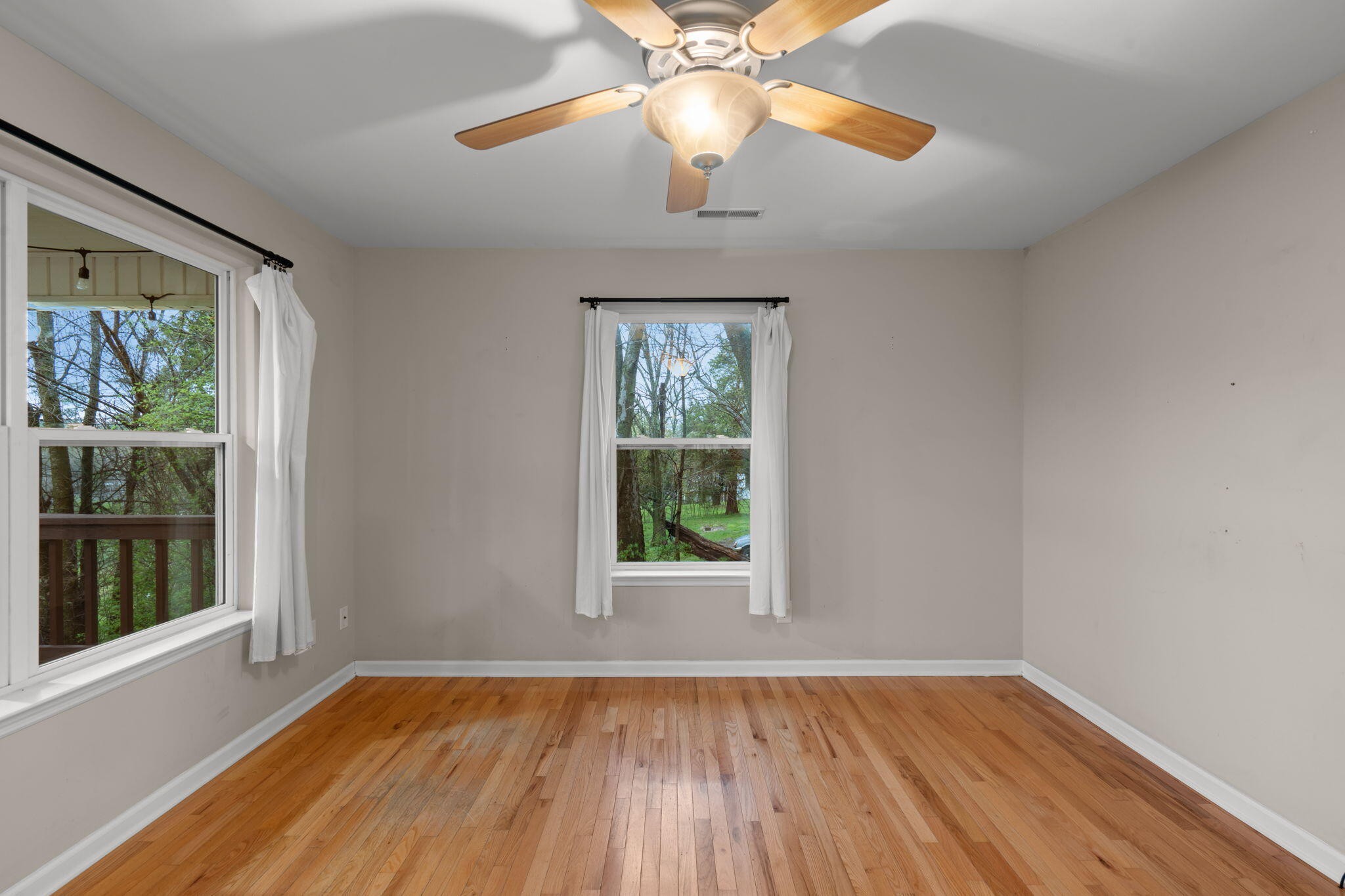 439 Town Creek Road Benton, TN 37307 - Photo 7 of 30 a view of an empty room with wooden floor and a window