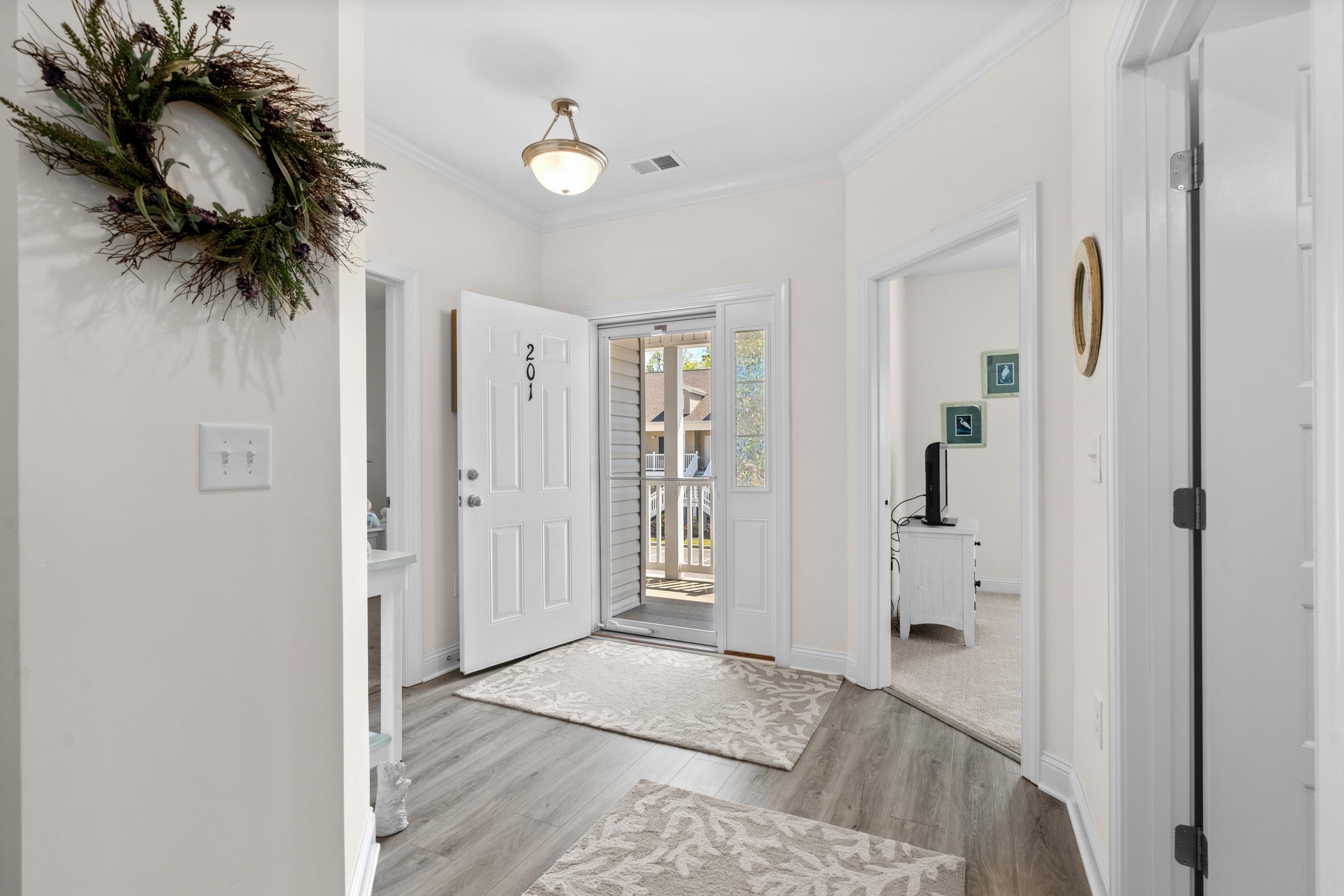 948 Jackline Place, Unit 201 Murrells Inlet, SC 29576 - Photo 3 of 37 Entryway with crown molding and light wood-style floors