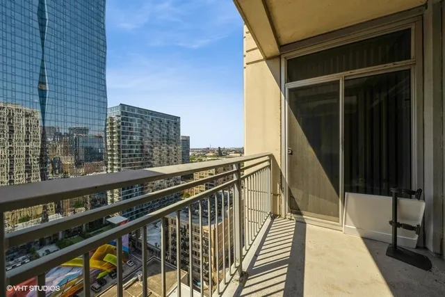 a balcony with view of car parked