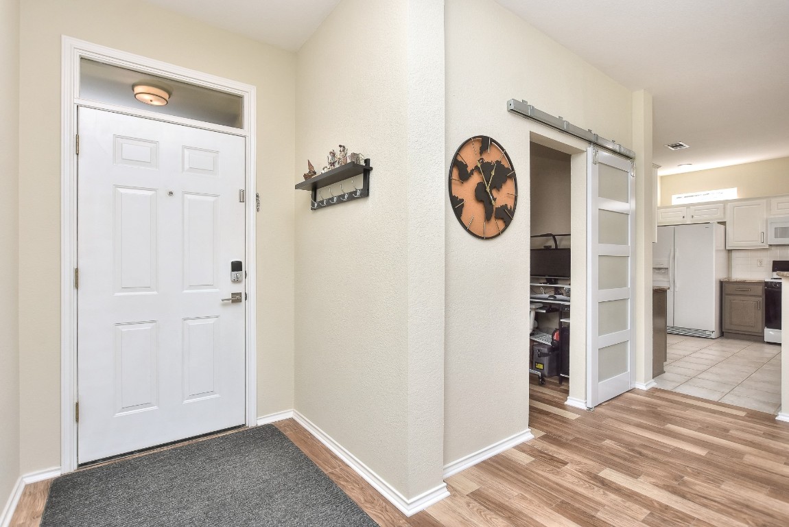 116 Dandelion Drive Georgetown, TX 78633 - Photo 4 of 31 Entryway featuring a sliding barn door for the office and ceramic tile flooring