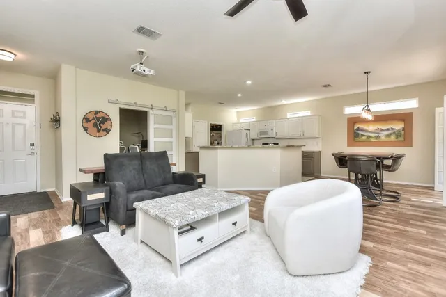 a living room with furniture and a wooden floor